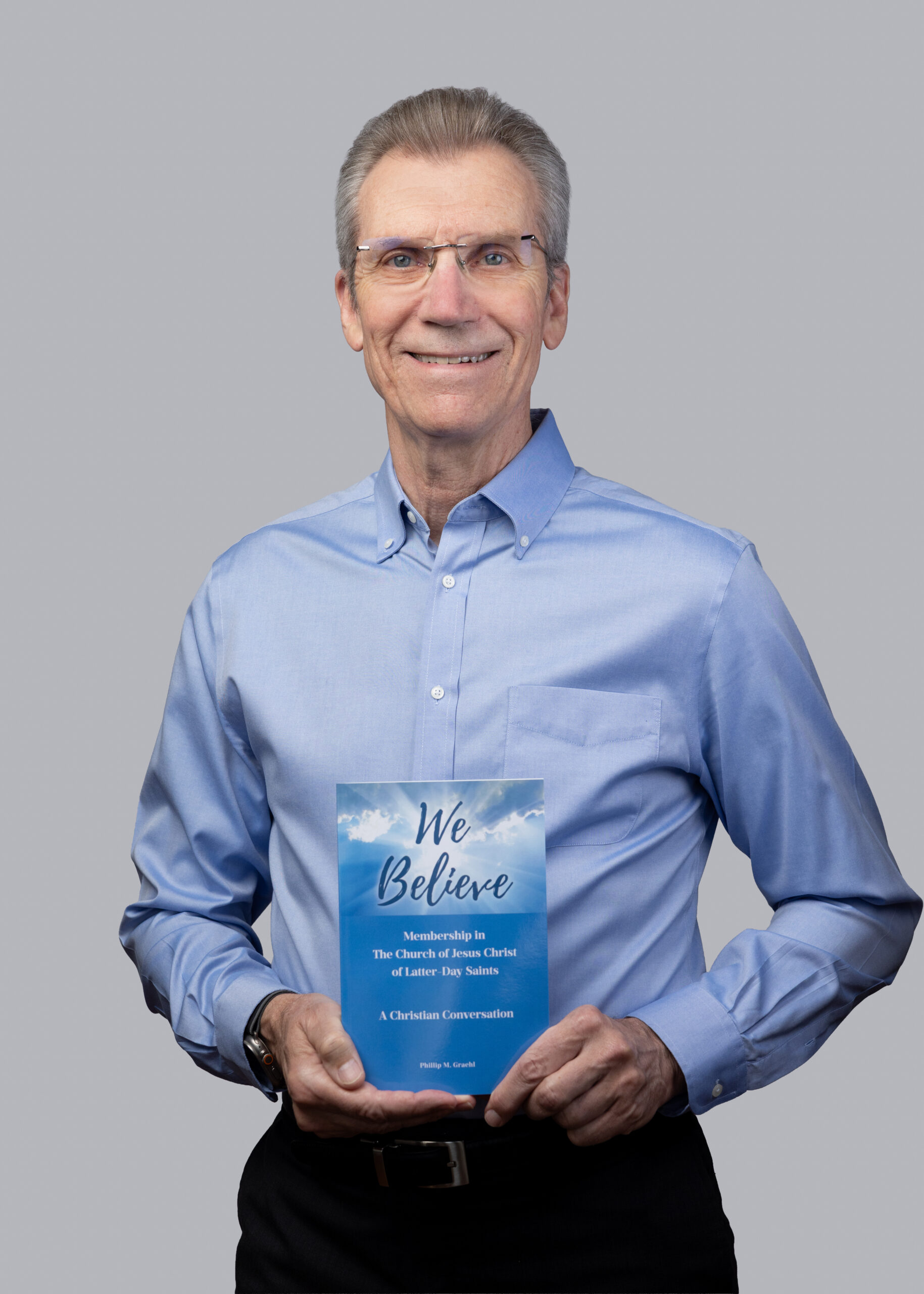 Professional author portrait holding We Believe