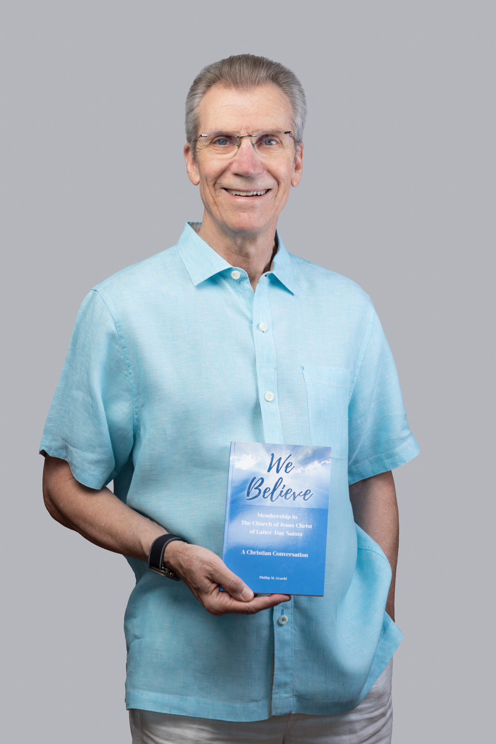 Professional author portrait holding We Believe